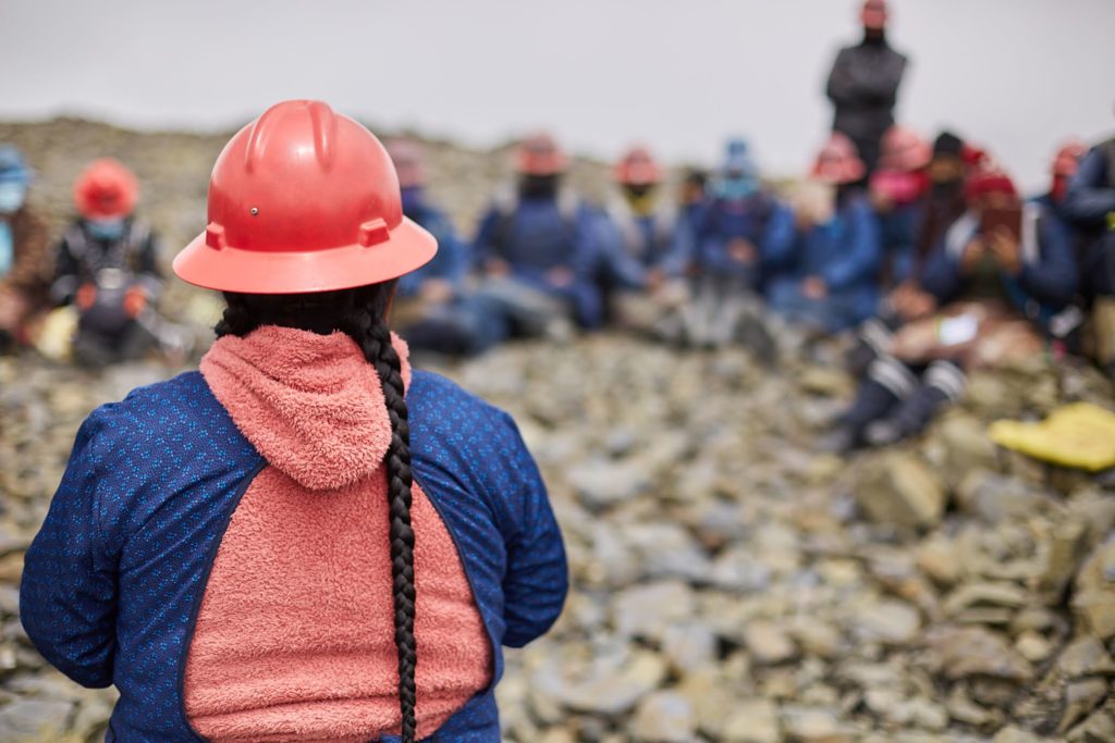 A 'pallaquera' artisanal small-scale miner looks out over rocks in La Rinconada mountains, Peru