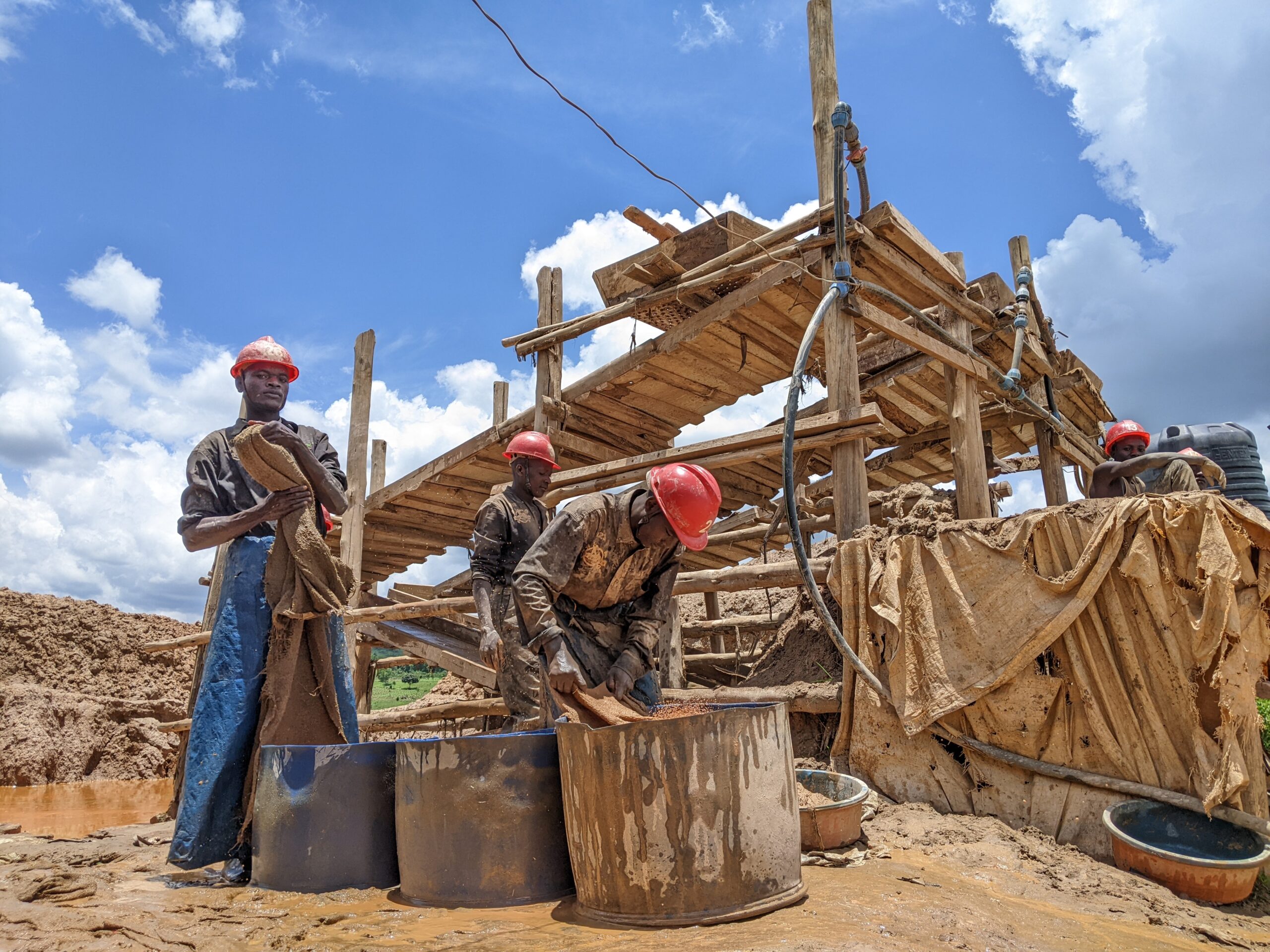 Miners panning for gold at a mine site in Kassanda District