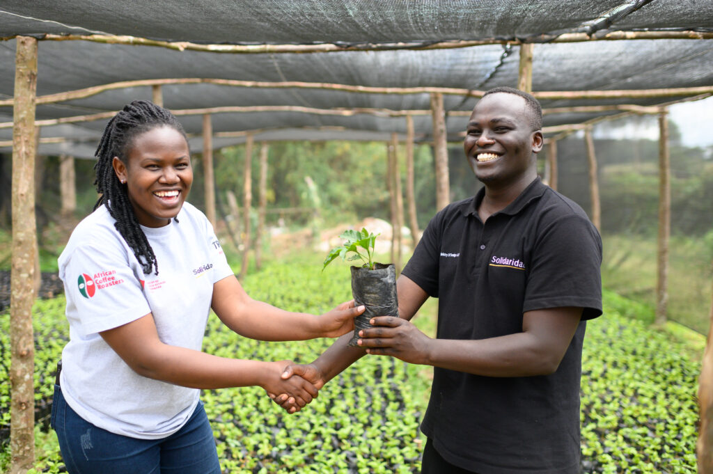Victor Murei (Right), a 23 year-old coffee farmer in his coffee nursery in Trans Nzoia, Kenya