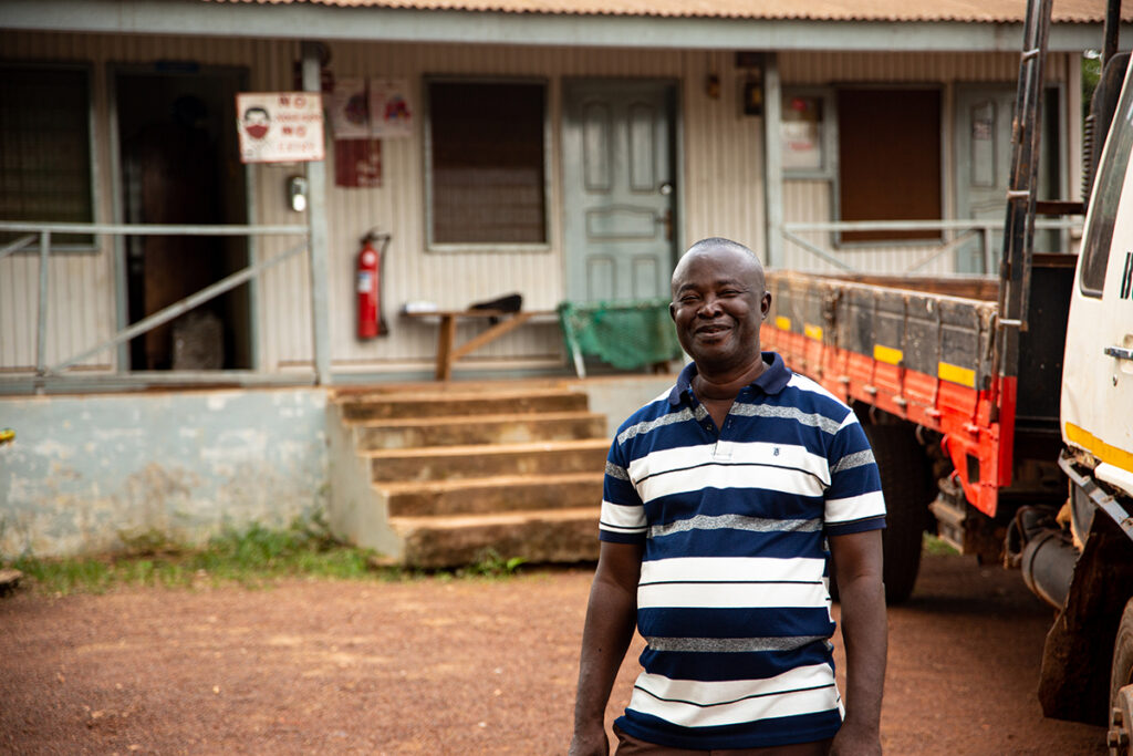 Aggregators like Mr Harold Agyako, who is pictured next to a work vehicle will also benefit from using the Harvest Alert tool.