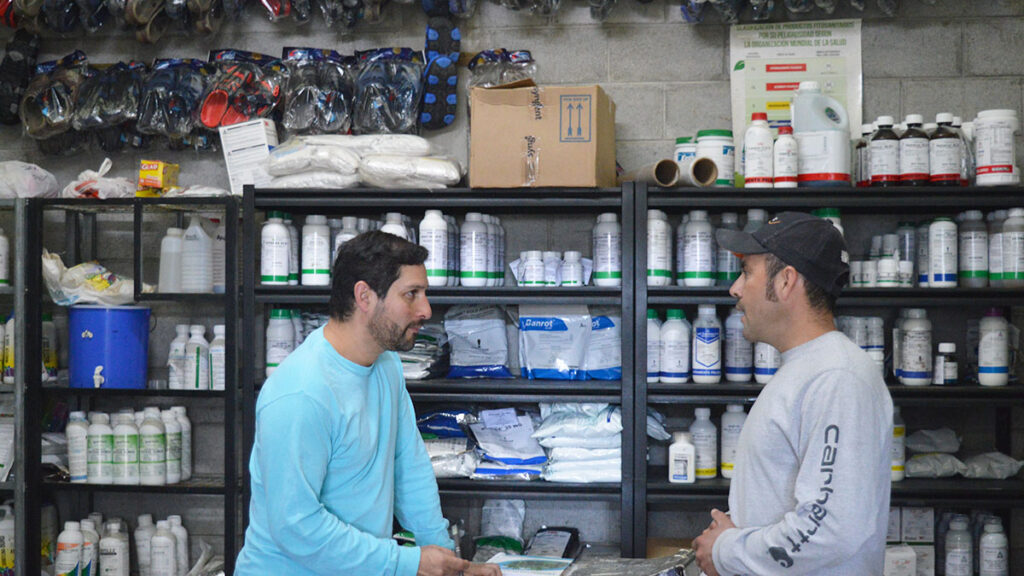 Here two men speak at an input store. Assessing labor conditions in the fruits and vegetables supply chains in Guatemala and Honduras has been possible by working in partnership with Syngenta
