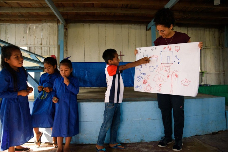 Author Lucia Hidalgo works with children to map their community in Peru