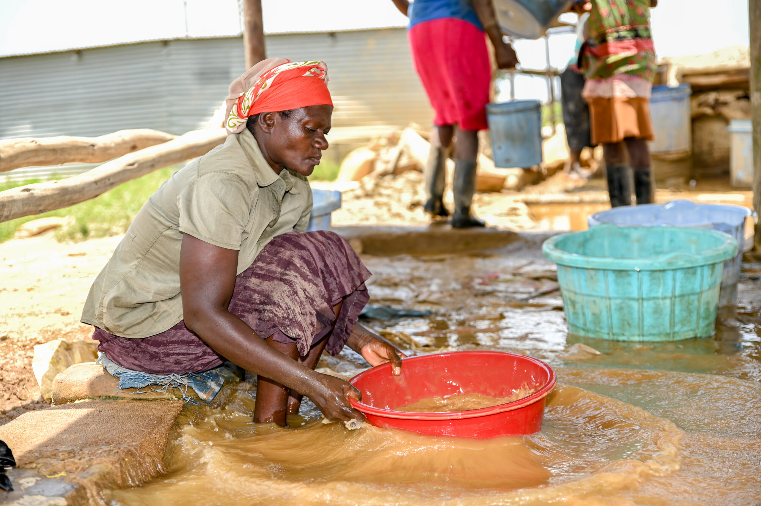 Gold, leather, and textiles sectors - Atieno processing gold amalgam at Osiri Mining Site