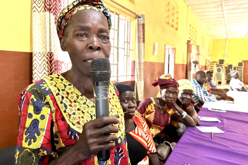 A woman shares her learnings with the group in her Village Area Land Committee